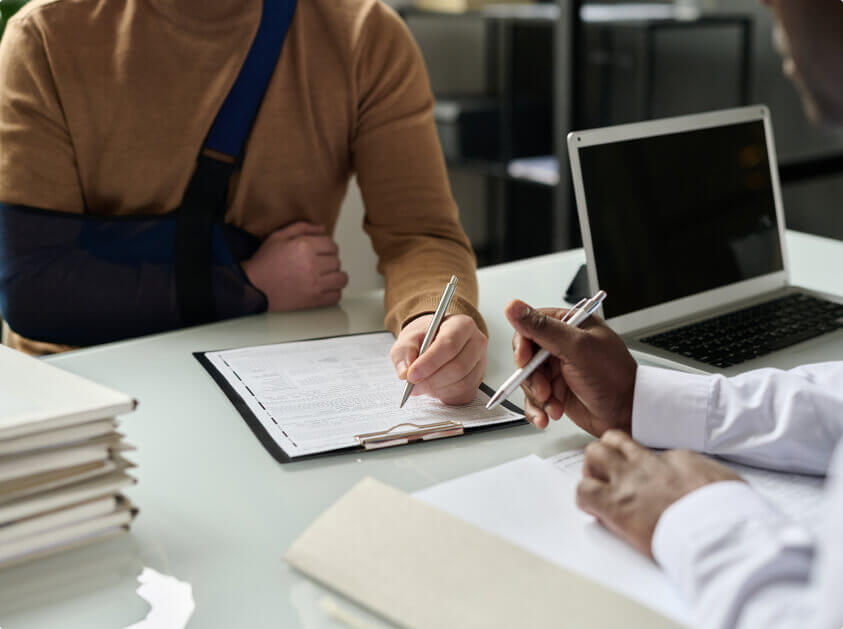 injured person filling in medical insurance forms